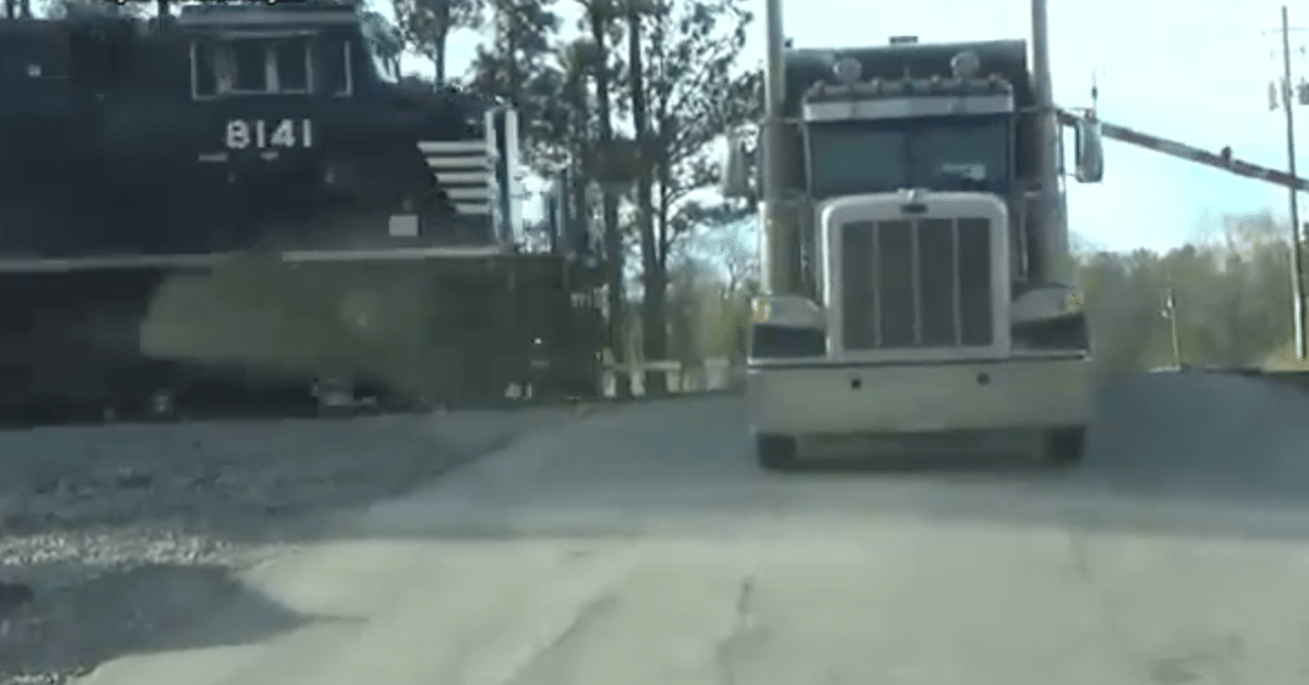Footage of Truck driver escaping semi before it's hit by a train ...