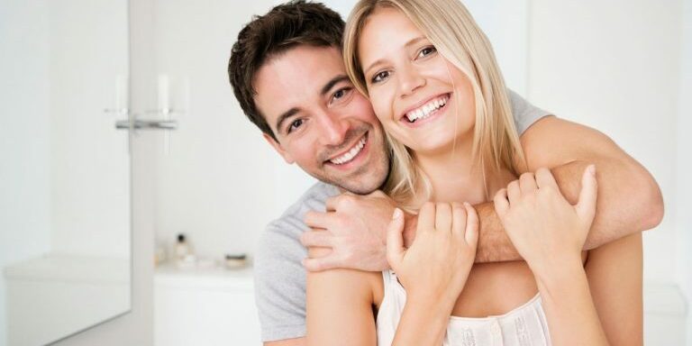 Portrait-of-a-happy-couple-embracing-in-bathroom